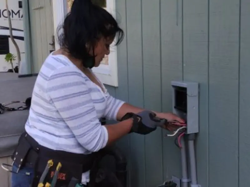 Licensed electrician wiring an exterior subpanel in Baxter Village